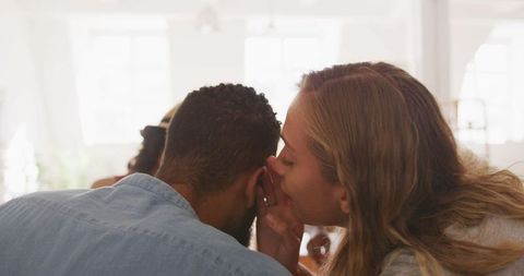 Friends relaxing at home sharing secrets