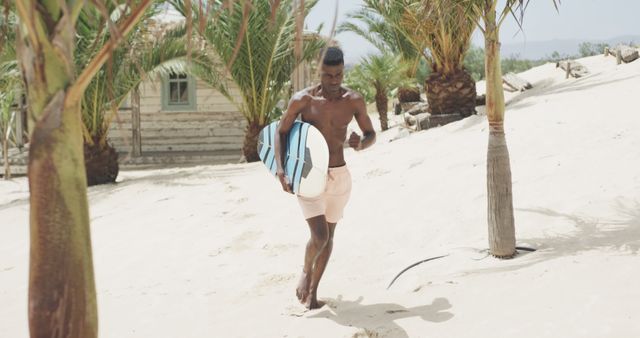 Young Man Walking with Surfboard on Tropical Beach - Download Free Stock Images Pikwizard.com