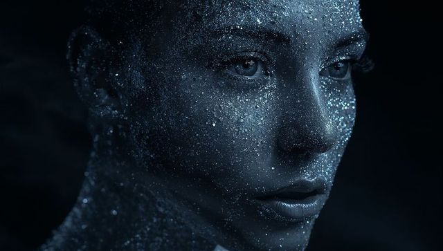 Closeup Moody Metallic Blue Face Portrait with Glittering Skin and Iridescent Sparkle