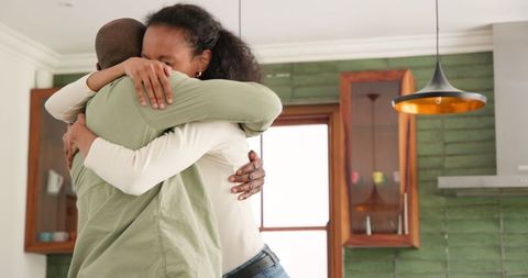 Diverse Couple Joyfully Dancing and Celebrating at Home