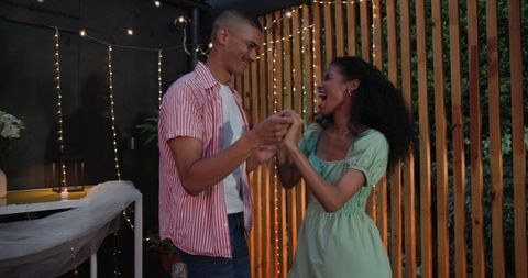 Diverse Couple Embracing on Romantic Patio Setting