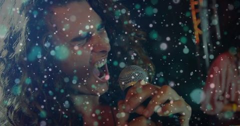 Energetic lead vocalist singing on vibrant concert stage