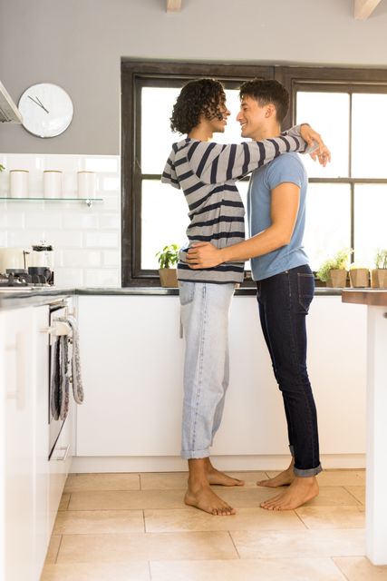 Loving Multiracial Gay Couple Embracing in Kitchen - Download Free Stock Photos Pikwizard.com