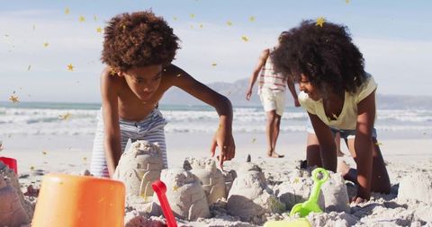 Children Building Sandcastles on Sandy Beach with Family