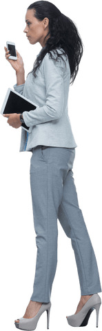 Elegant Businesswoman Holding Digital Tablet and Phone on Transparent Background - Download Free Stock Videos Pikwizard.com