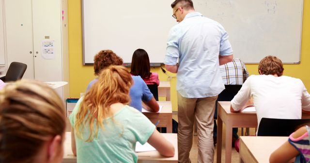 Teacher Overseeing Students During Classroom Exam - Download Free Stock Images Pikwizard.com