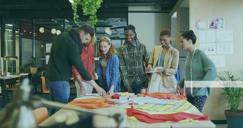 Creative team collaborating in modern design studio workshop