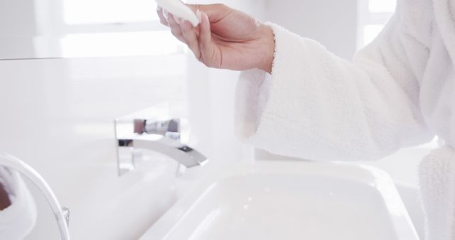 Woman Wearing White Bathrobe Preparing for Skin Care Ritual in Bright Bathroom - Download Free Stock Images Pikwizard.com