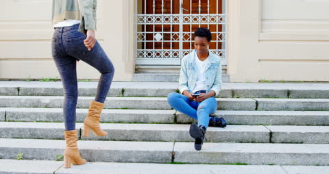 Urban Interaction Between Sisters on City Steps