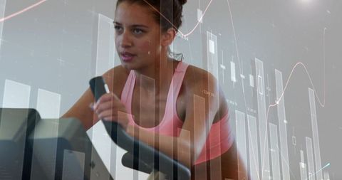 Female athlete pedaling on spin bike with candlestick charts overlay for fitness analytics