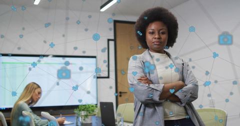 Confident Black Businesswoman Leading Digital Collaboration with Network Icons in Office