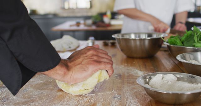 Hands Kneading Dough on Wooden Counter in Professional Kitchen - Download Free Stock Images Pikwizard.com