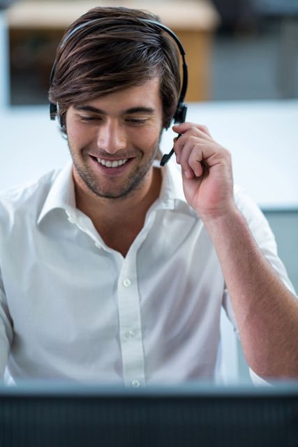 Smiling business executive with headsets in office