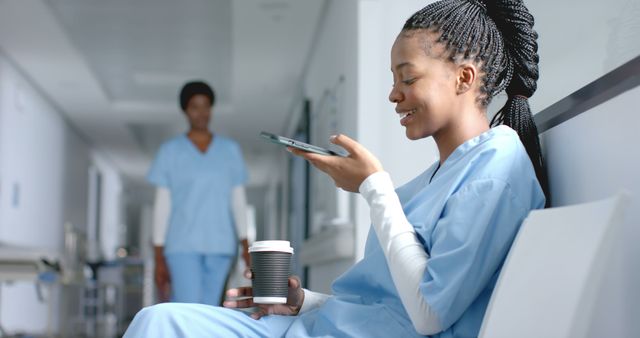 Healthcare Professional Using Smartphone During Break In Hospital Corridor - Download Free Stock Images Pikwizard.com