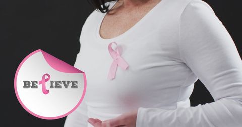 Woman Wearing Breast Cancer Awareness Pink Ribbon on Black Background