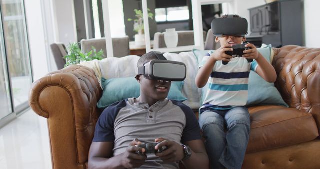Father and Son Enjoying Virtual Reality Gaming Together on Couch - Download Free Stock Images Pikwizard.com