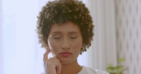 Bride with Curly Hair Experiencing Quiet Moment of Joy