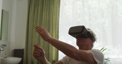 Senior Man Using VR Headset at Retirement Home