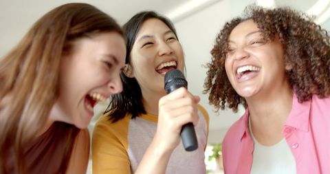 Diverse Female Friends Joyfully Singing and Laughing Together
