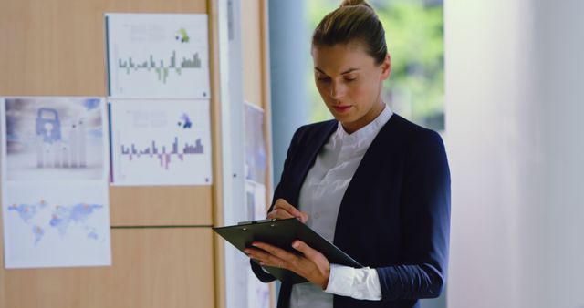 Professional Woman Analyzing Data in Office Environment - Download Free Stock Images Pikwizard.com