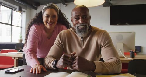 Diverse Business Team Smiling at Office Desk