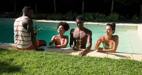 Diverse Friends Socializing at Backyard Pool on Sunny Day