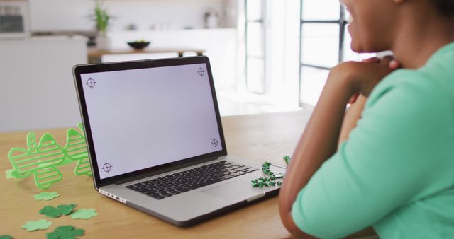 Woman Preparing St. Patrick's Day Decorations on Laptop at Home - Download Free Stock Images Pikwizard.com