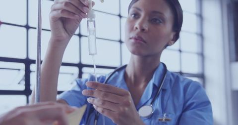 Nurse Adjusting IV Equipment in Clinic