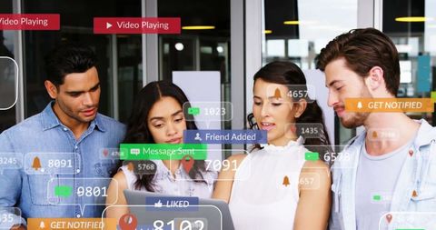 Young Professionals Engaging in Social Media Interaction on Laptop