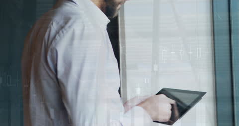 Caucasian Businessman Using Tablet with Dynamic Data Overlay