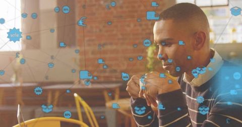 Tech-savvy professional working with digital network icons overlay