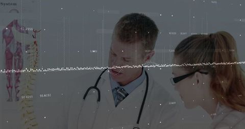 Medical experts analyzing spine model in clinic