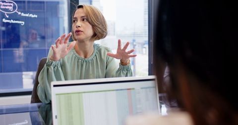 Businesswoman presenting ideas in office meeting