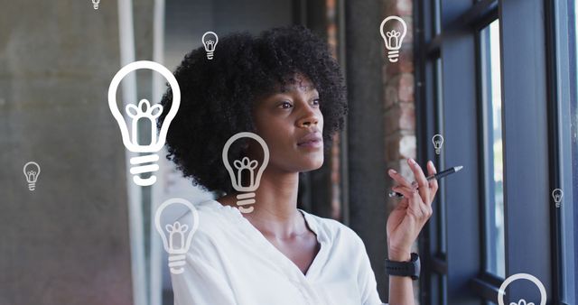 Thoughtful Black Woman Having Idea Moment with Light Bulb Icons - Download Free Stock Images Pikwizard.com