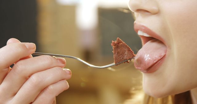 Close-Up of Woman Eating Chocolate Cake with Fork - Download Free Stock Images Pikwizard.com
