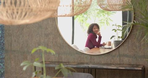 Woman Working Freelance in Cozy Cafe with Natural Ambiance