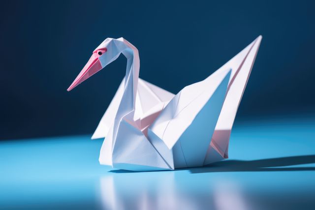 Close up of origami figure of swan on blue background, created using generative ai technology. Origami, art and japanese tradition concept digitally generated image.