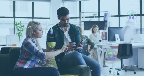 Diverse Team Discussing Digital Project with Futuristic Graphics