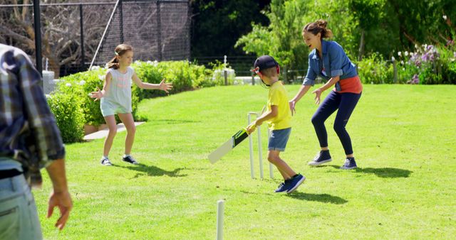 Family Playing Cricket Outdoors on Sunny Day in Park - Download Free Stock Images Pikwizard.com