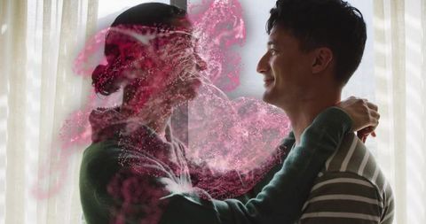 Couple embracing by window with dreamy pink powder swirl, backlit romantic moment