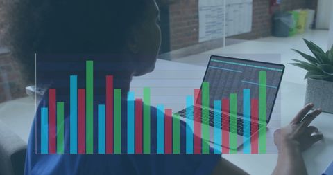 African American Businesswoman Analyzing Financial Data on Laptop in Office