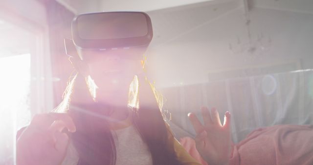 Woman Experiencing Virtual Reality with VR Headset in Bright Room - Download Free Stock Images Pikwizard.com