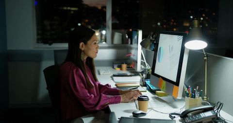 Focused Businesswoman Working Late at Office Desk - Download Free Stock Images Pikwizard.com