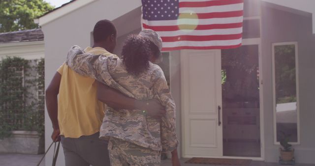 Happy african american soldier woman embracing husband after returning home from army. army, service, american patriotism and family concept.