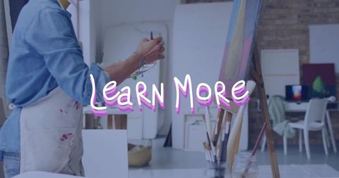 Artist painting on canvas in artistic studio setting