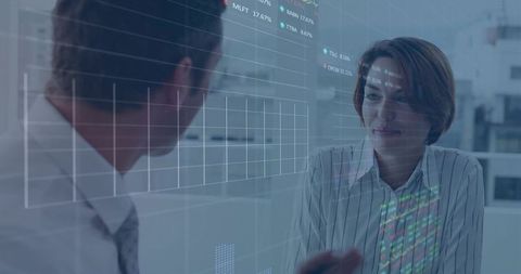 Business Professionals Analyzing Data on Transparent Interface at Office