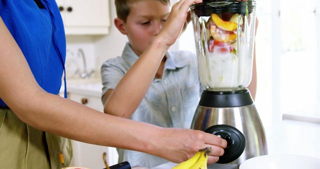 Mother and Son Making Fruit Smoothie in Kitchen - Download Free Stock Images Pikwizard.com