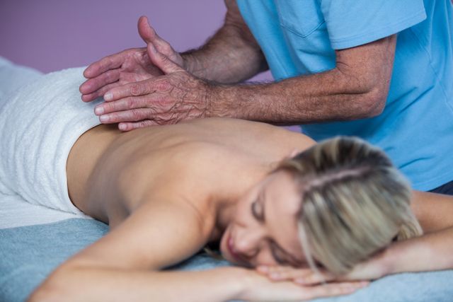 Woman Receiving Therapeutic Back Massage in Clinic - Download Free Stock Photos Pikwizard.com