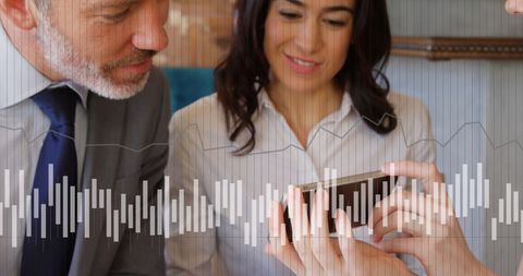Business professionals analyzing data on smartphone with graph overlay
