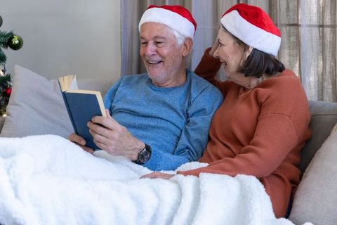 Senior Couple Reading Heartwarming Book in Festive Setting